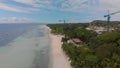 Panoramic view of the construction on a long sandy beach among the jungle