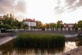 Panoramic view of the cottage village by the pond with green reeds at sunset. Life outside the city Royalty Free Stock Photo