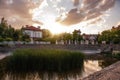 Panoramic view of the cottage village by the pond with green reeds at sunset. Life outside the city Royalty Free Stock Photo