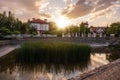 Panoramic view of the cottage village by the pond with green reeds at sunset. Life outside the city Royalty Free Stock Photo