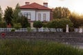 Panoramic view of the cottage village by the pond with green reeds at sunset. Life outside the city Royalty Free Stock Photo