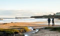 Panoramic View of Couple walking on the British Seaside at Sunset in Tynemouth, United Kingdom 01