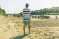 Panoramic view of cows herd walk in the summer sandy field near the river beach a Royalty Free Stock Photo