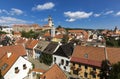 Panoramic view of Czech city Cesky Krumlov. European tile roof houses, a river and a bridge over it full of people in South