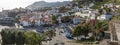 Panoramic view Camara do Lobos bay and harbour, a small touristic fisherman\'s village, main avenue facing the sea, boats and