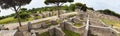 Panoramic view 180 degree in the excavation ruins at Ostia Antica - from the Decumanus Maximus to the gym of Neptune thermal Royalty Free Stock Photo