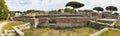 Panoramic view in 180 degrees of the Roman empire ruin and lush vegetation at archaeological excavations in Ostia Antica - Rome