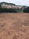 Panoramic view of a dirt soccer field and goal in a favela area. Sport in marginal urban areas. Football area Royalty Free Stock Photo