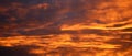 Panoramic view of dramatic fiery clouds at sunset