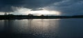 Panorami of dramatic stormy dark sky over the pond at spring, almost monochrome,siluette Royalty Free Stock Photo