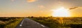 Panoramic View, on a dune landscape in the outback with a plain road to the horizon along the sunset in Denmark on the Island Romo