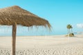 Panoramic view of empty broad beach with white sand blue sea sky background straw umbrella volleyball net. Sunny summer day Royalty Free Stock Photo