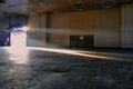 Panoramic view of empty industrial plant site beam of sunlight enters the raised gate Royalty Free Stock Photo