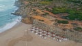 Panoramic view empty recliners umbrellas on seashore. No people beach coastline