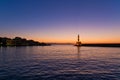 Panoramic view of the entrance to Chania harbor with lighthouse at sunset, Crete Royalty Free Stock Photo