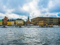 Panoramic view from the excursion boat on Royal Palace, tourist boats and waterfront houses of Gamla Stan Stockholm Sweden Royalty Free Stock Photo