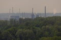 Panoramic view of a factory at the city of linz, austria. Dirty factory in the background of a nice beautiful forest. Contrast Royalty Free Stock Photo