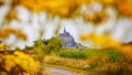 Panoramic view of the famous abbey of Le Mont Saint-Michel Normandy France framed by yellow flowers Royalty Free Stock Photo