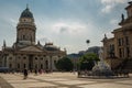 Panoramic view of famous Gendarmenmarkt square with Berlin Concert Hall and German Cathedral in golden evening light at sunset