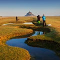 Panoramic view of famous historic Le Mont Saint-Michel tidal island on a sunny day with blue sky and clouds in summer, Normandy. Royalty Free Stock Photo