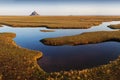 Panoramic view of famous historic Le Mont Saint-Michel tidal island on a sunny day with blue sky and clouds in summer, Normandy. Royalty Free Stock Photo