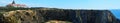 Panoramic view of the Farol Cabo Sardao lighthouse and nearby cliff in Portugal