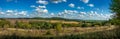 Panoramic view of fields, arable land, forests under a blue sky with clouds Royalty Free Stock Photo