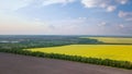 Panoramic view of a field and a village in the distance against a blue sky. Photo from the drone Royalty Free Stock Photo