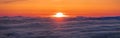 Panoramic view of a fiery sunset over a sea of clouds covering San Francisco bay area, California Royalty Free Stock Photo