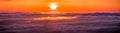 Panoramic view of a fiery sunset over a sea of clouds covering San Francisco bay area, California Royalty Free Stock Photo