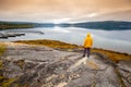 The young man standing on the rock and looking at the sea Royalty Free Stock Photo