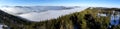 Panoramic view: Foggy mountain landscape in Austria. Beautiful mountain valley filled with early morning mist Royalty Free Stock Photo