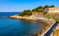 French Rivera rocky coastline of Pointe Belaye cape at Antibes resort city harbor onshore Azure Cost in France