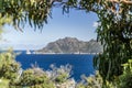 Panoramic view of Freycinet Peninsula, East Coast Tasmania, Australia, seen through blurry bushes at Cape Tourville Lighthouse. Royalty Free Stock Photo