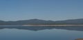 Panoramic view of the Gabriel y Galan reservoir with Granadilla in the background and a pine forest with firebreaks Royalty Free Stock Photo