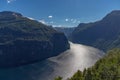 A panoramic view of the Gerianger fjord under bright sunlight