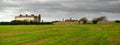 Panoramic view of ghotic building on green Irish field surrounded by rocky wall and hedge fence near Head Hook in Ireland