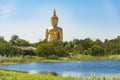 Panoramic view of Giant sitting Buddha against tropical landscape