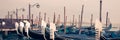 Panoramic view of gondolas and wooden pier in winter in Venice Italy