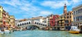 Panoramic view of Grand Canal, Venice, Italy. Rialto Bridge in the distance. It is famous landmark of Venice Royalty Free Stock Photo