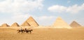 Panoramic view of Great Egyptian pyramids in Giza and three riders in front of them Royalty Free Stock Photo