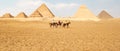 Panoramic view of Great Egyptian pyramids in Giza and three riders in front of them