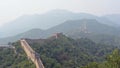 Panoramic view of the great wall zigzagging through the mountains surrounded of leafy forest. Mutianyu section, Beijing, China