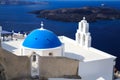 Panoramic view with Greek orthodox church with blue domes and sea in Oia in Santorini, Greece Royalty Free Stock Photo