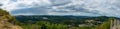 Panoramic view of green mountains of Crni Kal village under a cloudy sky in Slovenia