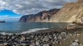 Guios beach with los gigantes cliffs and blurred tourists