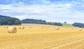 Panoramic view of harvested field with hay bales Royalty Free Stock Photo