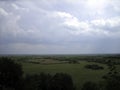 Panoramic view from the high bank to the water meadows beyond the river. Endless fields and forests stretch to the endless