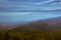 Panoramic view from a hill in the evening with low clouds over the valley