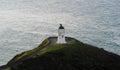 Panoramic view of historic white lighthouse landmark perched on oceanside clifftop Cape Reinga Northland New Zealand Royalty Free Stock Photo